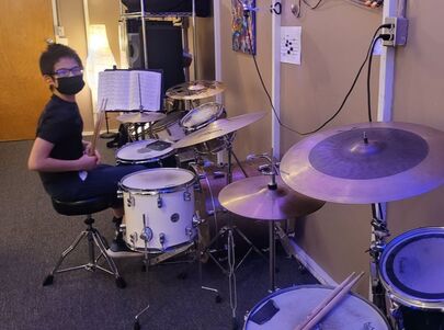 Picture of one of our students who is enrolled in our kids drum lessons program. He takes weekly drum lessons and is getting better at drums quickly