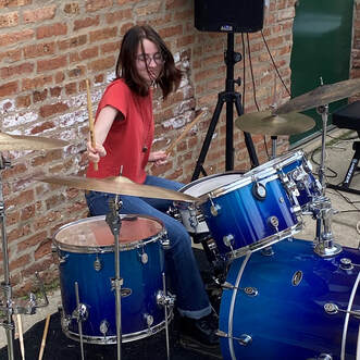 Picture of a student who is enrolled in our adult drum lessons program. We offer drum lessons for kids and drumming classes for adults as well.