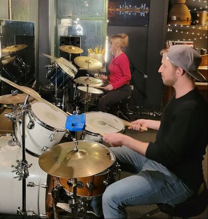 Action shot of a drum lesson. Sam is the drum teacher here with his student, M jamming in the drum lab! 